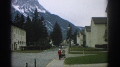 1963: a woman and two children walking on the street in a neighbourhood ZURICH