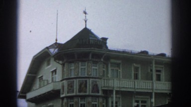 1963: Panorama of a Large Building in the Mountains of Zurich Switzerland