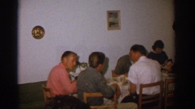 1963: Happy Family Eating Dinner While a Man Serves in Zurich, Switzerland