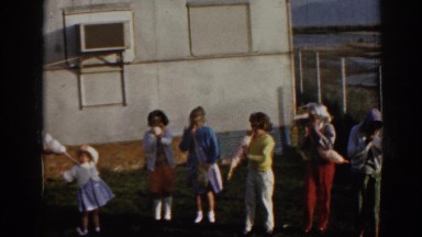 1962: few small girls playing some game & dancing & singing on some song.