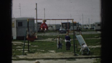 1962: kids swinging on the swing outside. EPHESUS TURKEY