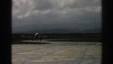 1962: military plane taxis along at an air force base, preparing for take off.