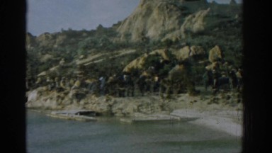 1962: a strange double exposure of various people and a rocky coastline IZMIR