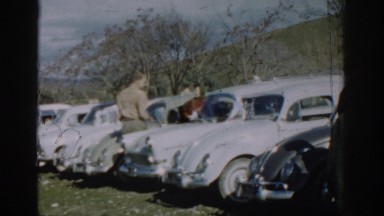 1962: people gathered around several cars in front of mountains IZMIR TURKEY