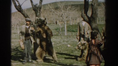 1962: a man talking and showcasing a bear which he maybe wanting to sell