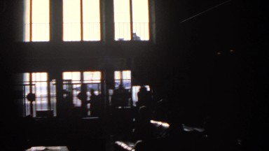 1963: Children Illuminated by Factory Window Light Work in Industrial Setting