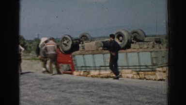 1962: truck accident crashed flipped over on roadside inspected by men