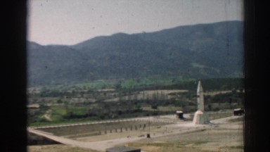 1962: white rocket is upright and centered in barren tracts of land