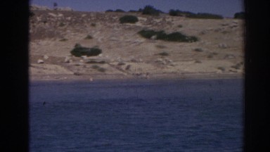 1962: a woman is skating through the blue water of the sea