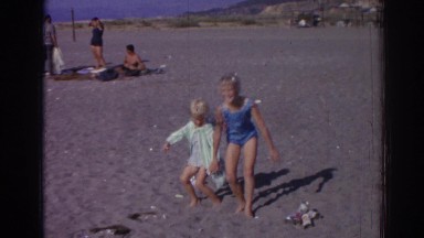 1962: two amazing kids playing in the sand of the beach IZMIR TURKEY