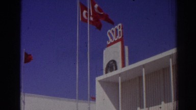 1962: red color flags are hoisted on a big white building IZMIR TURKEY