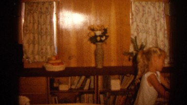 1962: Girl playing in home wood paneling pan