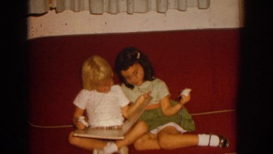 1962: young girls looking at a picture book together. IZMIR TURKEY