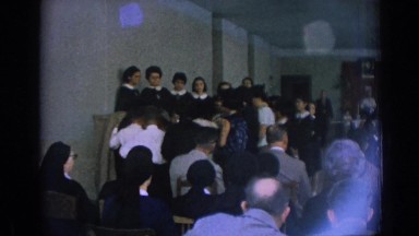 1962: nuns gathered in room listening to aspiring nuns kids singing IZMIR TURKEY