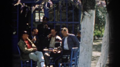 1962: a group of people sitting around a table and enjoying food, smoking