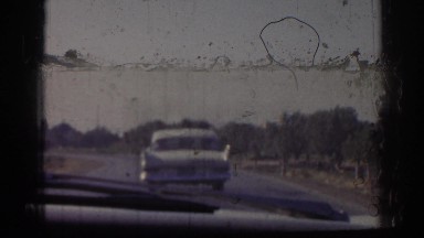 1962: man pulling bullock cart carrying weight cars moving on road IZMIR TURKEY