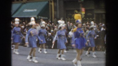 1962: a marching band doing a march in a street of people NEW YORK CITY