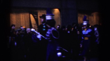 1962: marching band parading down street as onlookers watch NEW YORK CITY
