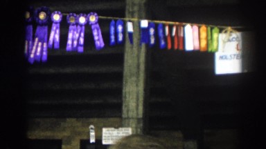 1963: a name board and festoons are hanging from the roof of a building