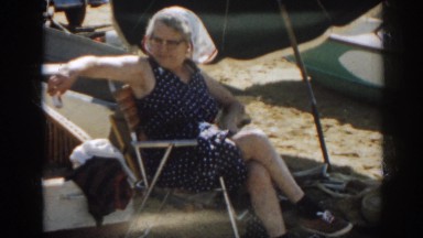 1963: woman sitting out by the lake. NEW JERSEY