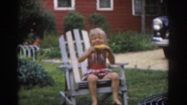 1963: a small child enjoying corn on the cob in the backyard NEW JERSEY