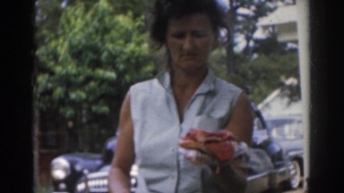 1963: a woman standing on the street corner. NEW JERSEY