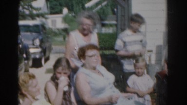1963: family all gathered together, socializing and having a great time.