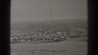 1937: black and white archive footage of camera panning over view of suburb