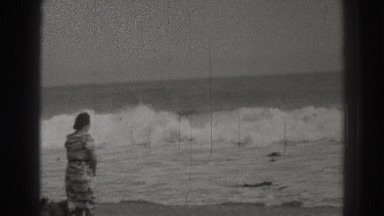 1937: woman and her dog paying on the beach. SANTA CRUZ CALIFORNIA