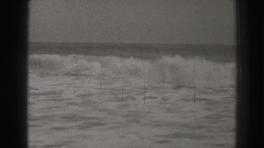 1937: waves crashing into the shore line. SANTA CRUZ CALIFORNIA