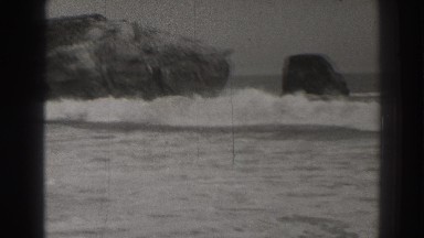 1937: watching the large wave come in on the ocean. SANTA CRUZ CALIFORNIA