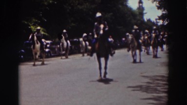1937: small crowd riding horses down the highway. TRUCKEE CALIFORNIA