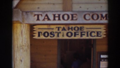 1937: a man enters a the old tahoe post office as a woman in sunglasses waits