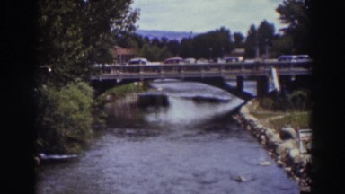1937: panoramic view of cars passing a bridge over a river TRUCKEE CALIFORNIA