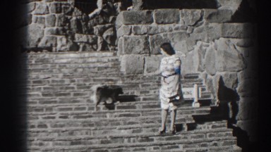 1938: woman walks her dog down hewn rock steps. BONNEVILLE DAM OREGON