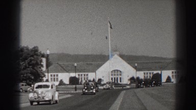 1938: cars driving down a street in front of a church BONNEVILLE DAM OREGON