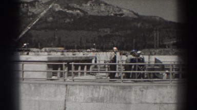 1938: engineers working on a cement wall such as a dam or lock. black and white