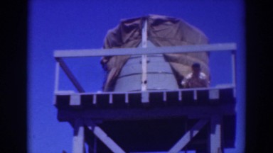 1937: man standing high above on water tank SACRAMENTO CALIFORNIA