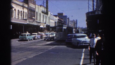 1967: Old Train in Downtown Brisbane Australia with Men Walking to Work