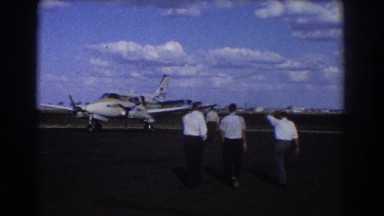 1967: People Walk Toward Small Plane on Beautiful Day Brisbane Australia