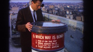 1967: A Man Carefully Opening a Barrel on a Rooftop in Sydney, Australia