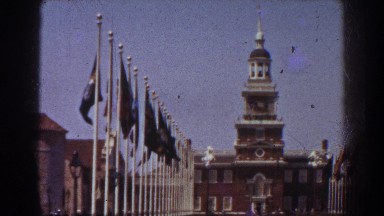 1939: Front of a Large Courtyard with Flags and a Big Building in the Background