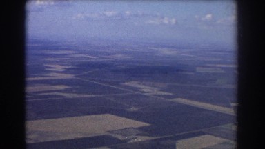 1967: airplane viewing of a normal field and city. BRISBANE AUSTRALIA