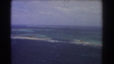 1967: footage of a series of islands in an ocean, filmed from the air PERTH