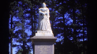 1967: white statue in a beautiful park, beautiful background color trees