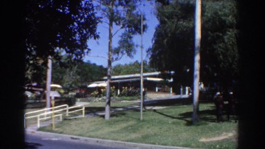 1967: two people walking on a breezy day PERTH AUSTRALIA