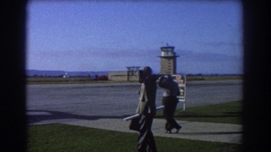 1967: two men walk towards an airplane on a runway at the airport PERTH