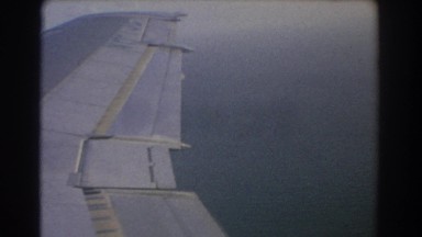 1967: close up of gray plane wing segments while in flight in the air PERTH