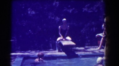 1937: a large extended family enjoying a hot summer day in the backyard pool.