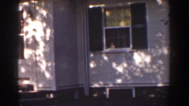 1939: a man with a hat and suit steps out the door of a house MOUNT WASHINGTON